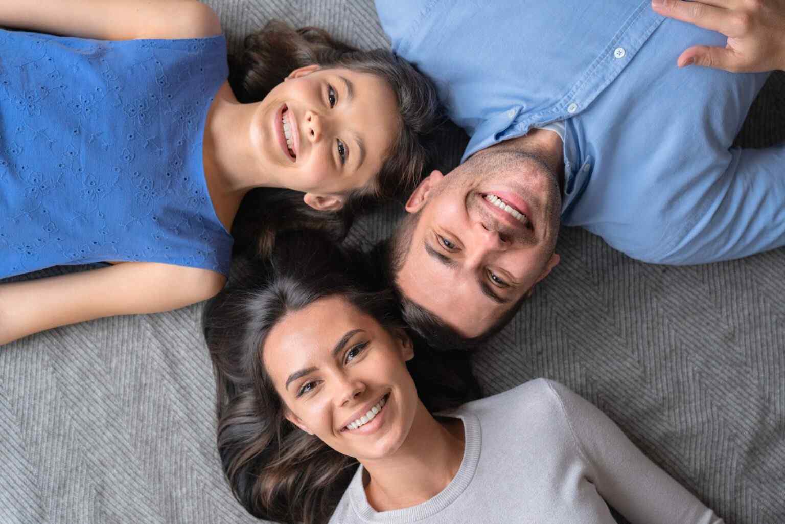 happy-family-concept-top-view-of-happy-family-of-three-bonding-to-each-other-and-smiling